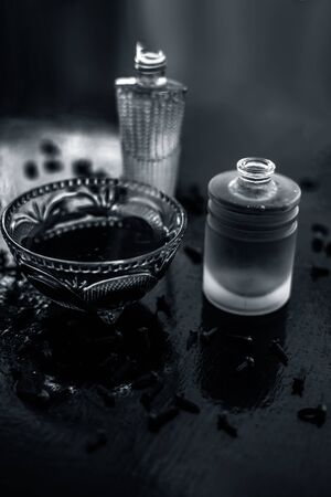 Face mask of clove oil on wooden surface consisting of clove oil and olive oil for the treatment of cleaning dirt and black heads from the skin.の写真素材