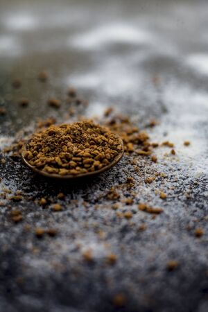 Hair growth remedy of rice flour water and fenugreek seed powder on wooden surface.の写真素材