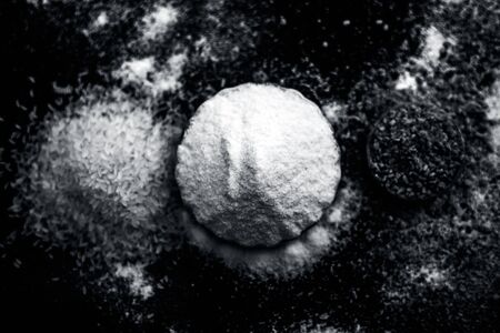 Hair growth remedy of rice flour water and fenugreek seed powder on wooden surface.の写真素材