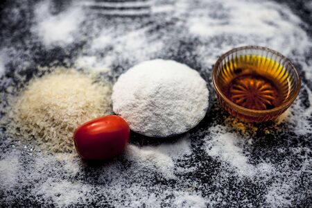 Face mask for oily skin on wooden surface consisting of rice flour,honey,tomato juice in a glass bowl along with some rice flour spread on the surface for greater effect.Horizontal top shot.の写真素材