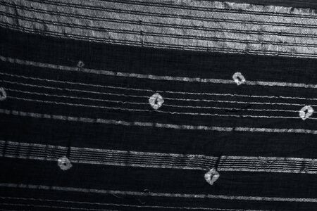 Brown colored fabric texture along with the white colored minimal design on it for the enrichment of...