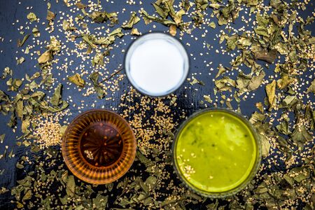 Neem or Indian Lilac face mask on the black wooden surface for Anti-aging benefits of neem leaves paste, oatmeal, milk, and honey.の写真素材