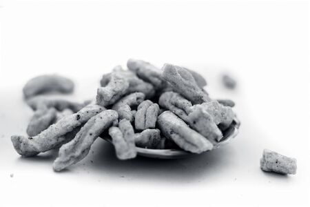 Famous Indian Gujarati snack dish in a glass bowl isolated on white i.e. Vanela gathia or vanela gathiya.Snack prepared with gram or chickpea flour and black pepper, salt and other ingredients.の写真素材