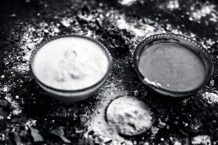 Neem or Indian Lilac face mask on the black wooden surface for acne and scars consisting of gram flour, neem paste, and some curd.の写真素材