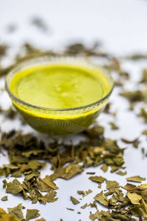 Neem or Indian Lilac face mask isolated on white for acne and scars consisting of gram flour, neem paste, and some curd.の写真素材