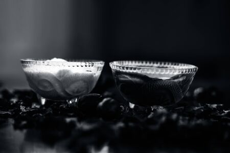 Nutmeg face mask to treat to even out discolorations and pigmentation on your face on the wooden surface consisting of Nutmeg powder, lemon juice, and curd.の写真素材