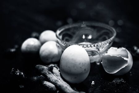 Face mask of lemon juice, honey, and curd along with some raw turmeric well mixed in a glass bowl along with entire raw ingredients on the wooden surface for acne-prone skin and blemishes.の写真素材