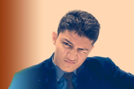 Portrait shot exhausted of apprentice young businessman isolated on gradient background wearing a blue colored shirt and black necktie and expressing tired laziness on his face.の写真素材