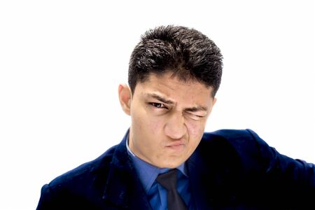 Portrait shot exhausted of apprentice young businessman isolated on white wearing a blue colored shirt and black necktie and expressing tired laziness on his face.の写真素材