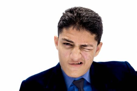 Portrait shot exhausted of apprentice young businessman isolated on white wearing a blue colored shirt and black necktie and expressing tired laziness on his face.の写真素材