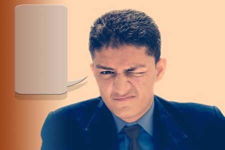 Portrait shot exhausted of apprentice young businessman isolated on the gradient and expressing tired laziness on his face. With and bubble or chat shape expressing ides.の写真素材