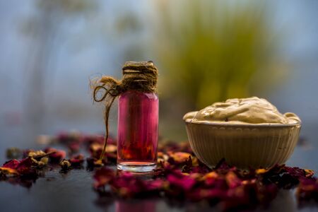 Ubtan/face mask/face pack of Multani mitti or fuller's earth on wooden surface in a glass bowl consisting of Multani mitti and rose water for the remedy or treatment of oily skin.On wooden surface.;の写真素材