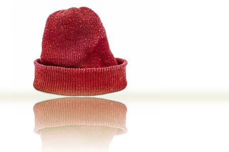 Hand knitted red-colored woolen cap isolated on white indicating Christmas.の写真素材