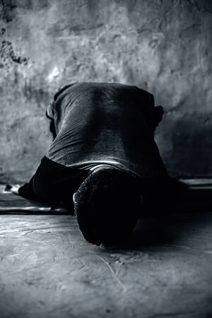 Young energetic male teenager model doing Paschimottanasana or Forward fold on a colorful mat.の写真素材