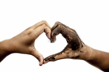 White hand along with the support of black hand making heart shape isolated on white.Concept of equality, happy valentine's day, etc.の写真素材