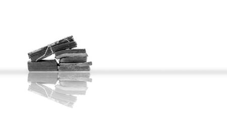 Old vintage books stacked on each other isolated on white with its reflection.の写真素材