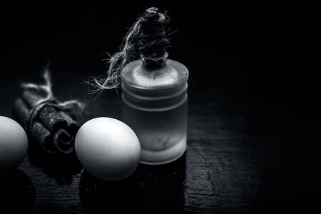 DIY hair mask of cinnamon, egg and olive oil on a wooden surface.Shot of oilve oil, egg and cinnamon...