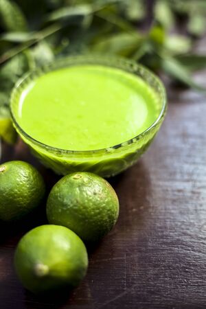 Hair remedy of all-purpose ayurvedic medicinal herb i.e. Neem or Nim or Indian lilac in a glass bowl along with neem leaves and freshwater for dandruff or hair skin itching problems.Vertical shot.の写真素材