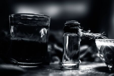 Hair remedy of all-purpose ayurvedic medicinal herb i.e. Neem or Nim or Indian lilac in a glass bowl along with neem leaves, freshwater & tea tree oil for dandruff or hair skin itching problems.の写真素材