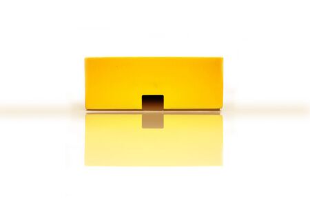 Yellow-colored glossy package, parcel, mobile, wrapping box isolated on white background. Box...