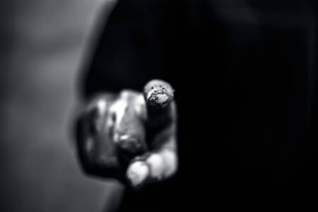 Dirty hand of farmer wearing t-shirt with mud under his nails and touching something virtual.Concept...