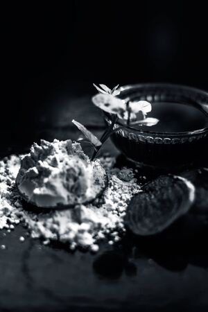 Face mask for a natural glow for all skin types on the black wooden surface consisting of some beetroot juice, yogurt, lime juice, and gram flour. Shot of face mask with entire ingredients.Vertical shot.の写真素材