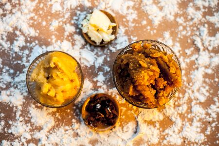 Indian Gujarati popular dish Atte ka sheera or Halwa-Karah parshad in a glass bowl on a brown...