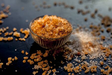 Close up shot of gond/goond/edible gum crystals in a transparent glass bowl on a black glossy...
