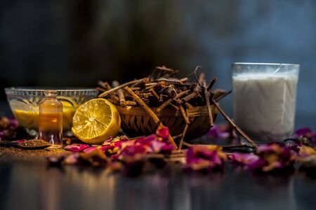Face mask of manjistha or Indin madder root on a black wooden surface consisting of manjistha roots powder, lemon, milk and some essential rose oil. Face mask used for minor skin infections and acne.の写真素材