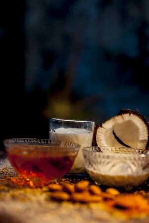 Complete face mask of coconut, consisting of coconut milk, rose water, yogurt, buttermilk, oatmeal, almonds, lime juice, turmeric, rice flour, honey, olive oil, and sandalwood powder. Vertical shot.の写真素材