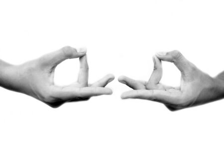 Human hands doing Akash Yoga Mudra isolated on a white-colored seamless background. Shot of pair of hands demonstrating Akash Mudra.の写真素材