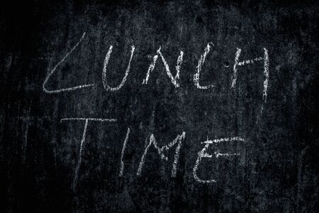 Lunch Time wrote on rough texture wall with white-colored chalk, horizontal shot.の写真素材