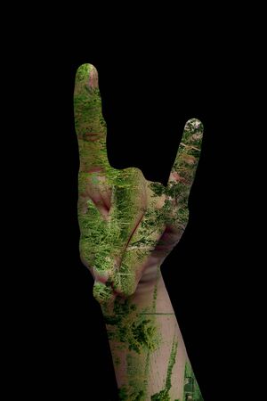 Double exposure shot of pair of hands with some hand sign and having healing nature. Concept of Care for mother nature.の写真素材