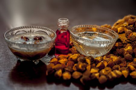 Close up shot of DIY shampoo made at home in a glass bowl consisting of some soapnut ell mixed ith essential oil, backing water, and some water.の写真素材
