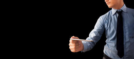 Portrait shot of corporate businessman posing isolated on black background.
