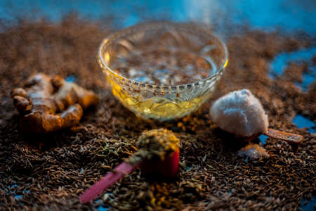 Face mask for preventing acne on a black wooden surface of betel leaves and turmeric powder.の写真素材