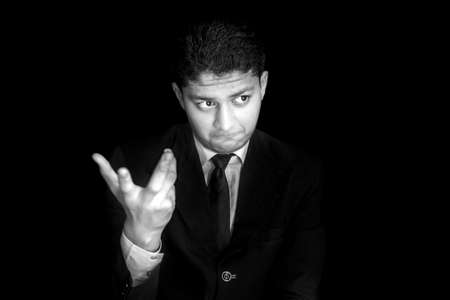 Portrait shot of a businessman adjusting his tie before a meeting isolated on black background.