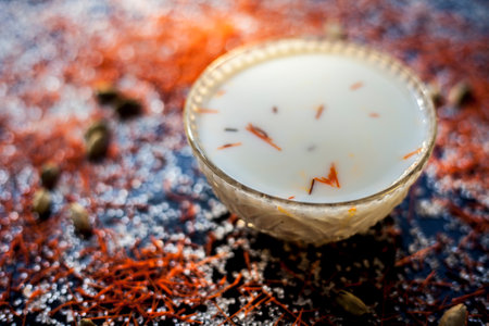 Kesar milk or saffron milk in a glass bowl along with saffron spread on the surface.の写真素材