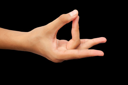 Female hand showing OK sign isolated on black background with clipping path.の写真素材