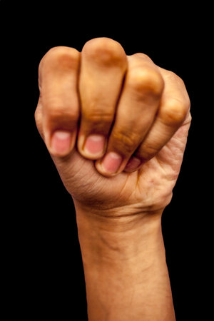 Fist of a man isolated on a black background with clipping pathの写真素材