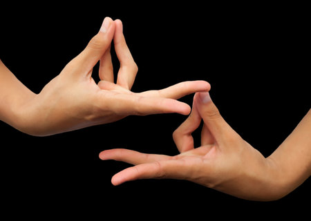 Hands of a woman and a man isolated on a black backgroundの写真素材
