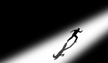 Shot of an athlete running towards the light (success).
