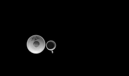 Top shot of an empty used teacup isolated on black background.