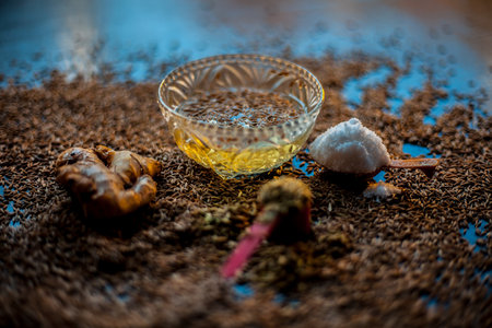Shot of cumin seeds, sea salt, ginger powder,fennel seeds on brown surface for curing bloating.の写真素材