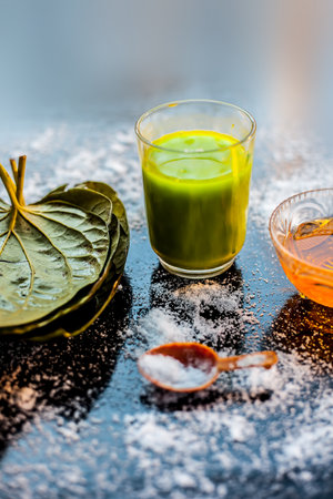 Face mask for controlling oiliness consisting of betel leaves juice, honey, sea-salt on a black...