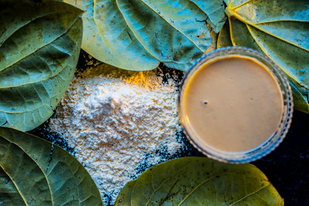 Face mask for nourishing your skin consisting of betel leaves, besan or chickpea powder, Multani mitti, or mulpani mitti on a black surface.の写真素材