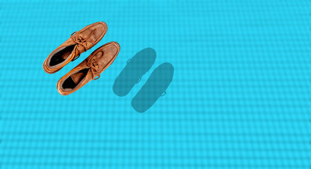 Top shot of black shoes floating on swimming pool water.の写真素材