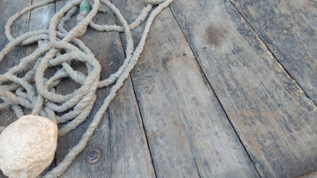 Rope and a stone on a wooden deck with copy space.の写真素材