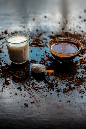 Close up shot of gram flour powder well mixed with milk in a glass and entire raw ingredients present on the surface.の写真素材