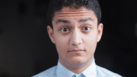 Male model raising eyebrows, Concept of skepticism, wonder on black background.